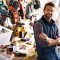 Portrait of a handsome young handyman standing in front of his work tools